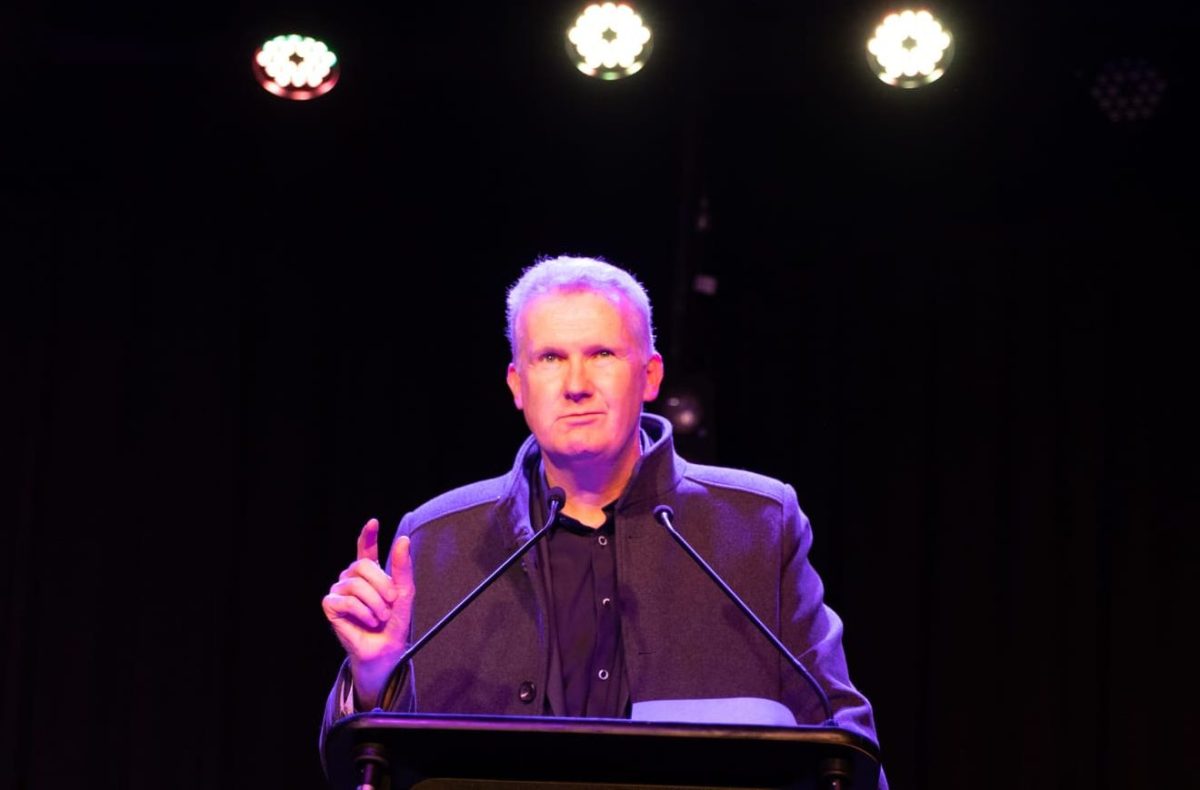 A man (Tony Burke) at a podium.