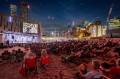 Audience watching silent cinema with live scores at Fed Square Melbourne.